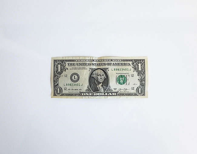 A picture of a one-dollar bill representing the importance of pricing, a business tip from Elijah Norton.